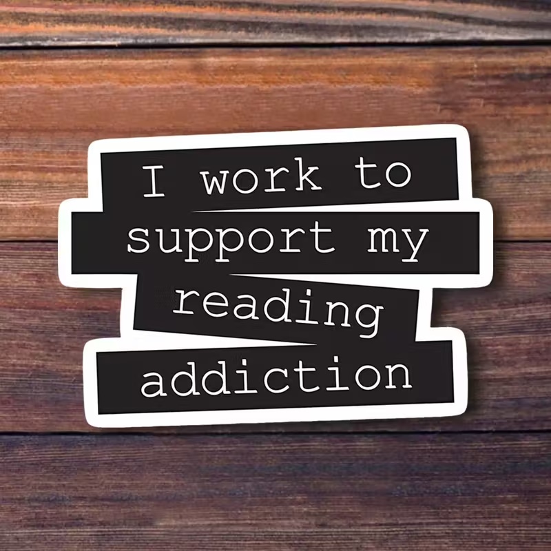 Наліпка з написом «I work to support my reading addiction»